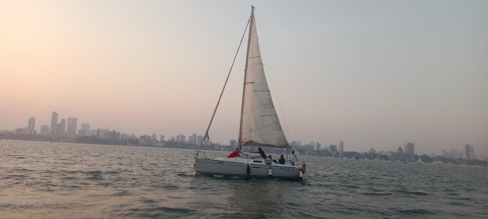 Sailboats at sunset off the Mumbai coastline